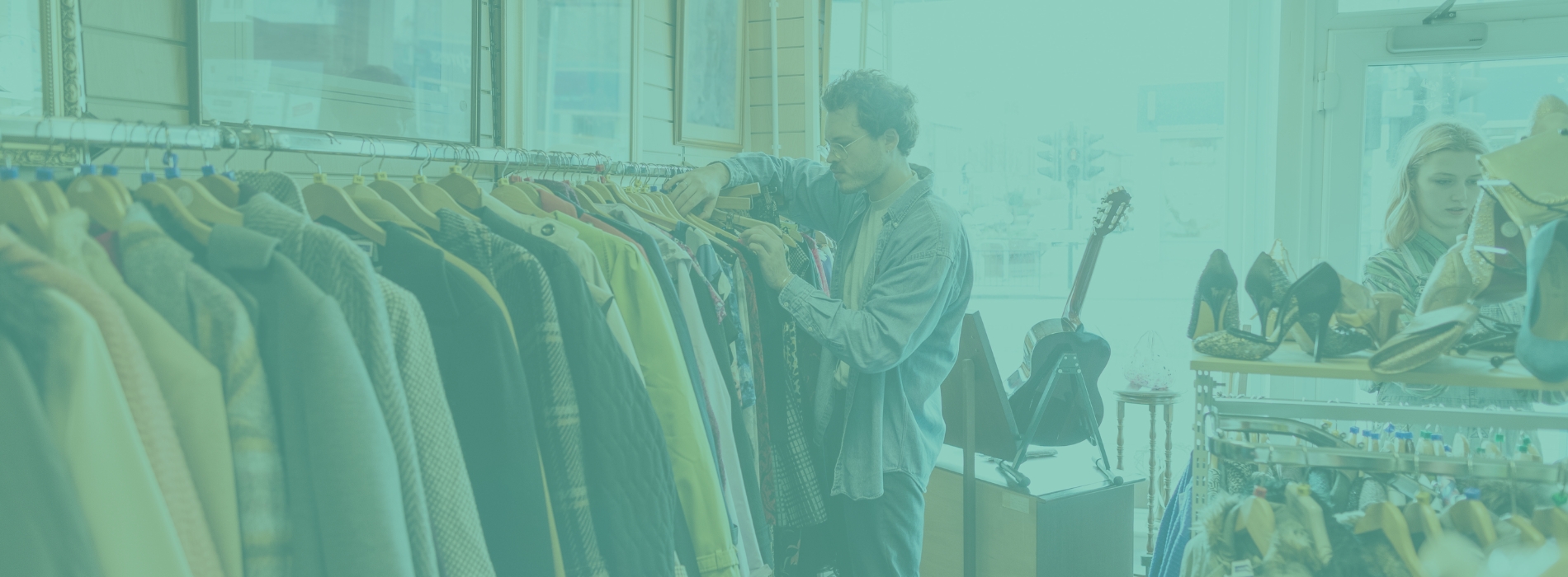 Volunteer arranging donated clothing in a charity retail store